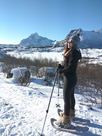 Portrait of man standing on snow covered mountain