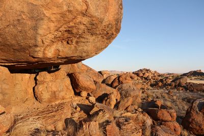 Rock formations on landscape against clear sky