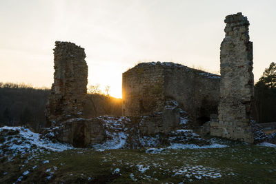 Old ruin against sky during winter