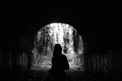 Silhouette of man in tunnel