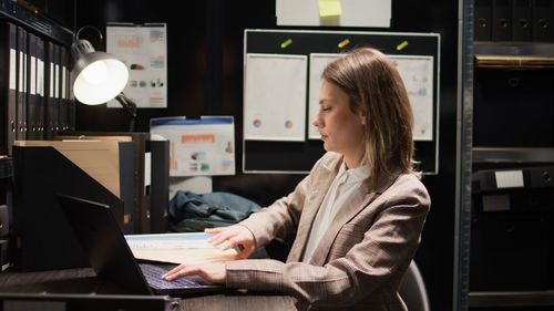 Young woman using laptop at table