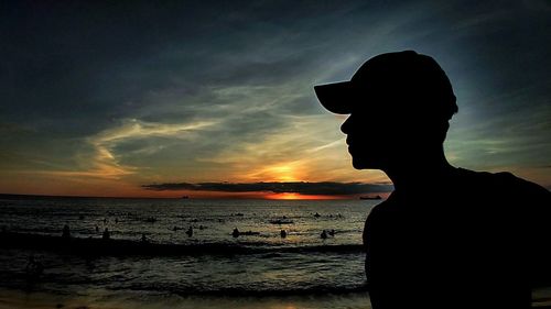 Silhouette of man at beach during sunset