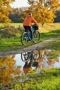 Man riding bicycle on field