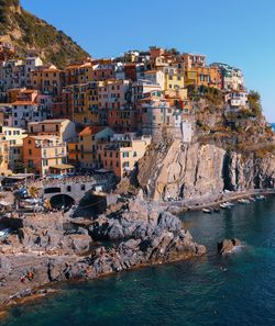 Townscape by sea against clear sky