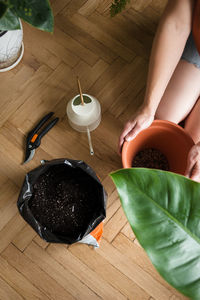 High angle view of woman hand on table