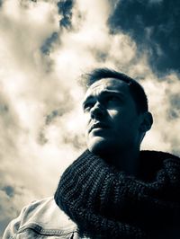 Low angle view of man looking away against sky