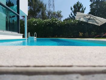 Surface level of swimming pool against blue sky