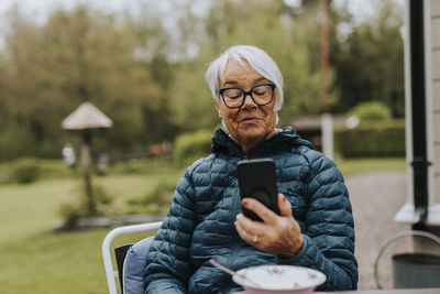 Smiling woman using phone