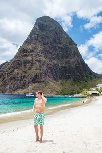 Rear view of woman standing at beach