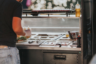 Midsection of man preparing food in kitchen