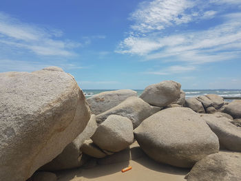 Rocks on beach against sky