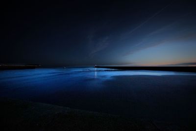 Scenic view of sea against clear sky at night