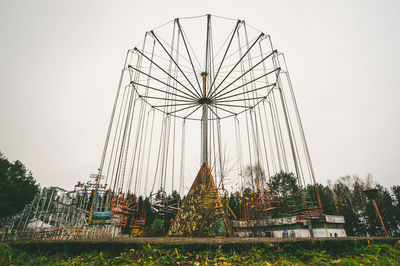 Low angle view of ferris wheel against sky