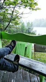 Low section of man sitting on railing