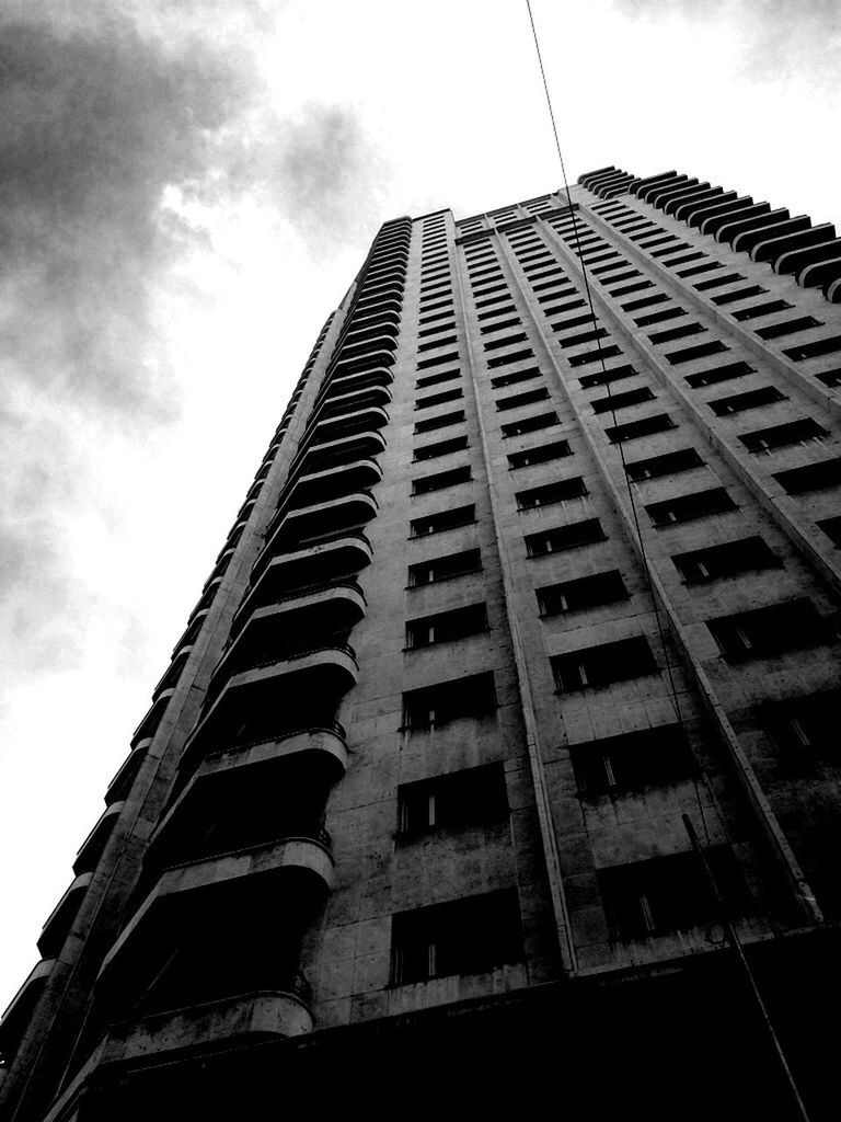 architecture, low angle view, built structure, building exterior, tall - high, sky, modern, city, skyscraper, office building, tower, building, tall, day, glass - material, window, outdoors, no people, cloud - sky, reflection