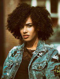 Portrait of young woman with curly hair