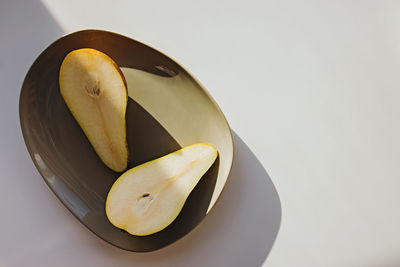 Modern minimal still life, pears on a plate in natural light. top view with copy space