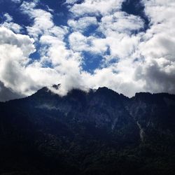 Scenic view of mountains against cloudy sky