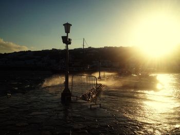 Pier on sea at sunset