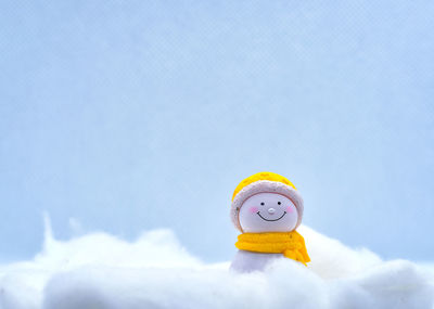 Close-up of toy hat against blue sky during winter