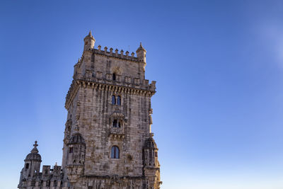 Low angle view of clock tower against blue sky