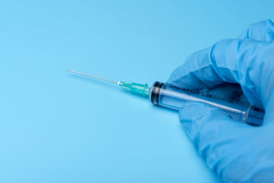 Close-up of human hand on blue background