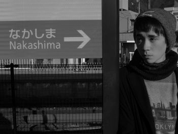 Man standing by information sign