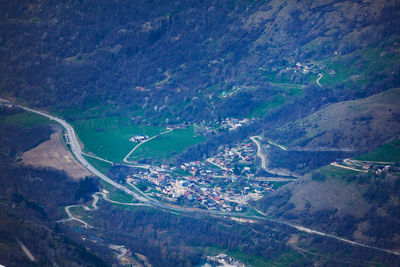 High angle view of airplane flying over land