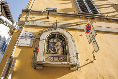 Low angle view of cross by building