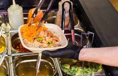 Close-up of hand holding food in restaurant