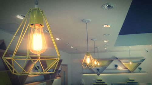 Low angle view of lit light bulb at night