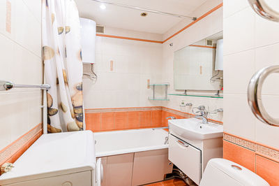 Low section of woman standing in bathroom