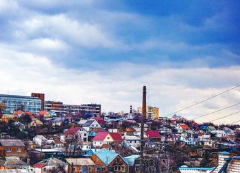 Buildings against cloudy sky