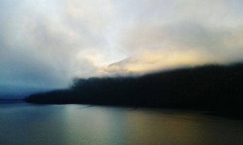 Scenic view of sea against storm clouds