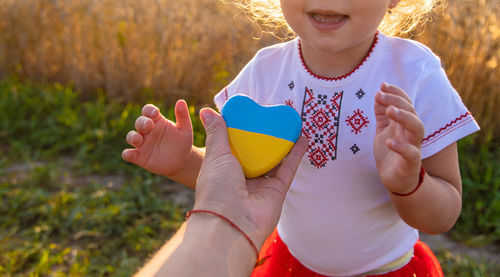 Close-up of woman holding heart shape