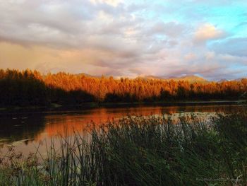 Scenic view of lake against sky during sunset