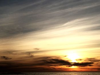 Scenic view of dramatic sky over sea during sunset