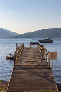 Pier over sea against clear sky