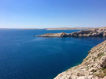 Scenic view of sea against clear blue sky