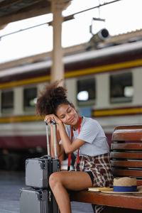 Side view of young woman using mobile phone