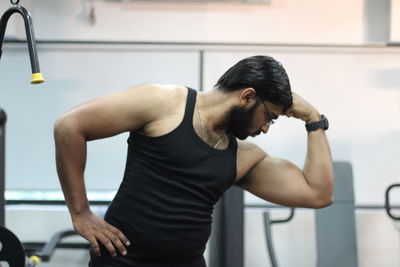 Man flexing muscles at gym