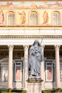 Low angle view of statue against historic building