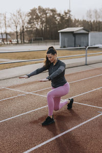 Woman exercising at running track