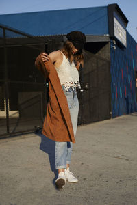 Young woman standing on road