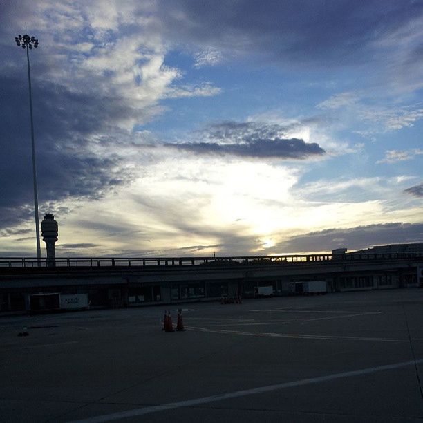 sky, street light, cloud - sky, built structure, architecture, railing, transportation, sunset, connection, the way forward, bridge - man made structure, road, lighting equipment, cloudy, cloud, street, outdoors, building exterior, nature, diminishing perspective