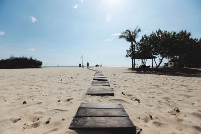 Boardwalk at beach against sky