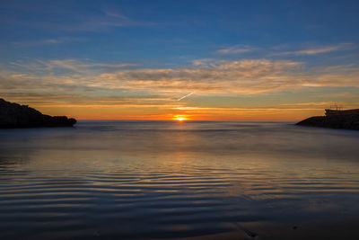 Scenic view of sea against sky at sunset