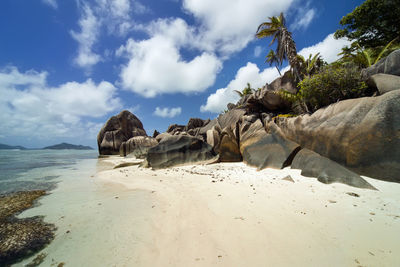 Panoramic view of rocks on beach against sky