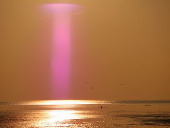 Scenic view of sea against sky at sunset