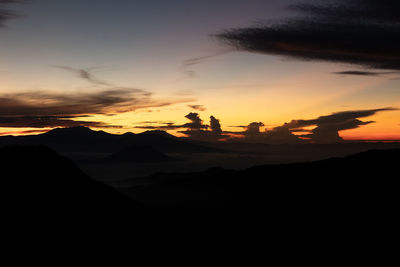 Scenic view of silhouette mountains against sky during sunset